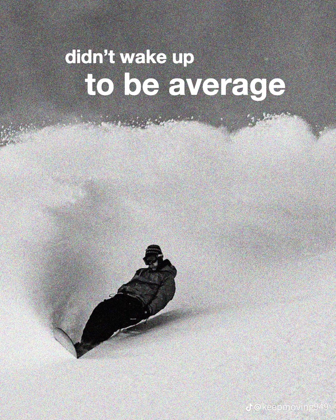 A grainy, black-and-white photograph of a snowboarder carving through deep, powdery snow. The snowboarder is positioned in the lower center, leaning into a turn that has kicked up a large, dramatic spray of snow behind them. The top of the image features large, white text overlaid on a dark sky. There is a small watermark in the bottom right corner.
