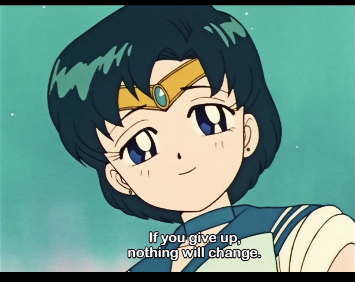 An anime-style close-up shot of a female character with short dark blue hair and large blue eyes. She is wearing a gold tiara with a green gemstone and a blue and white sailor-style uniform. She has a gentle, encouraging smile on her face. The background is a soft, teal gradient with small white sparkles. Subtitles at the bottom of the image read, 'If you give up, nothing will change.'
