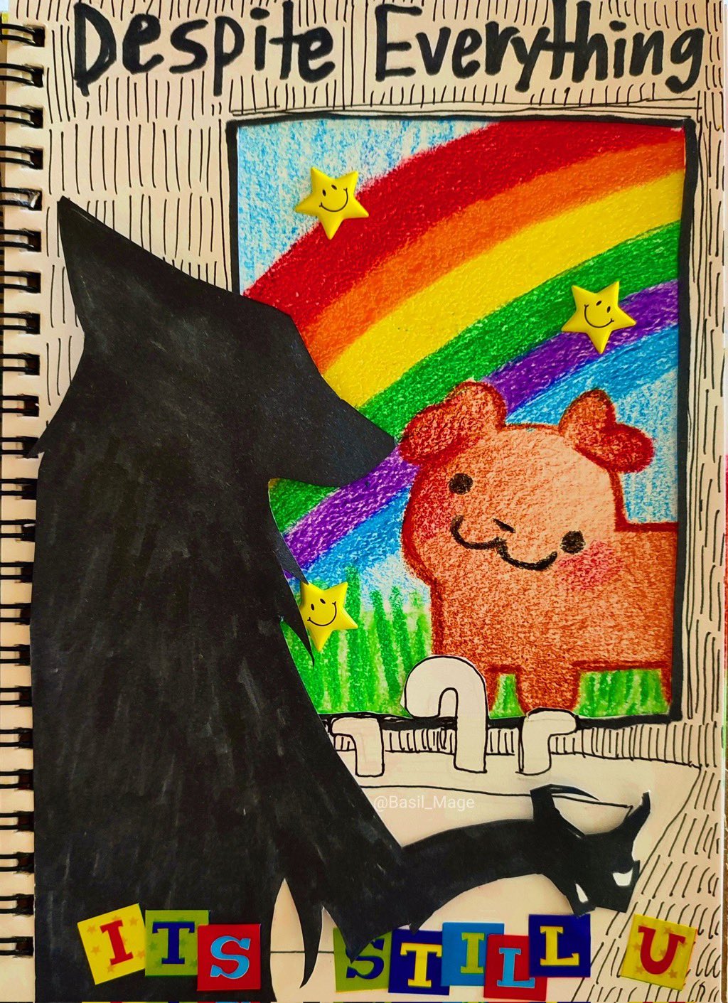 A hand-drawn illustration in a sketchbook, likely fan art for the game OMORI. On the left, a large, black silhouette of a wolf-like creature (Omori) looks toward a bright, colorful drawing inside a rectangular frame. The drawing inside the frame features a vibrant rainbow, green grass, three yellow smiling stars, and a smiling orange bear-like character (Aubrey/Something). At the top, hand-lettered text reads 'Despite Everything'. At the bottom, colorful letter cut-outs spell out 'ITS STILL U'. A small watermark '@Basil_Mage' is visible near the bottom center.