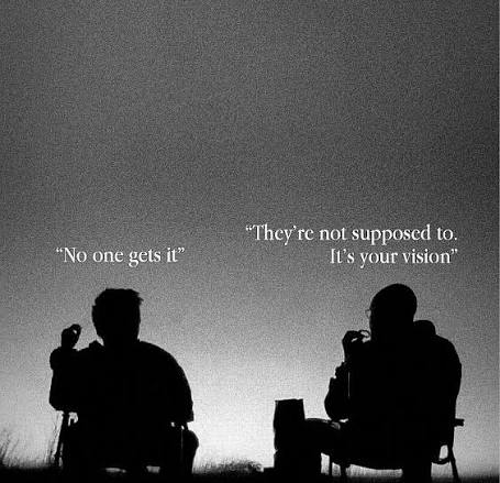 A black and white, grainy, high-contrast photograph depicting the silhouettes of two people sitting in chairs, viewed from behind. They appear to be looking out toward a vast, empty horizon or a hazy landscape under a dim sky. The overall mood is contemplative and somber. Centered in the frame, there is white text overlaid on the image.