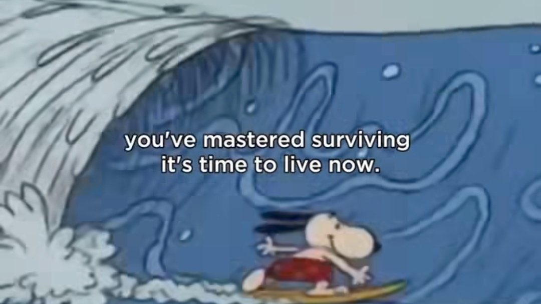 An animated scene featuring Charlie Brown from the Peanuts comic strip surfing on a large, blue wave. He is wearing red swim trunks and is balanced on a yellow surfboard. White text is overlaid in the center of the image.