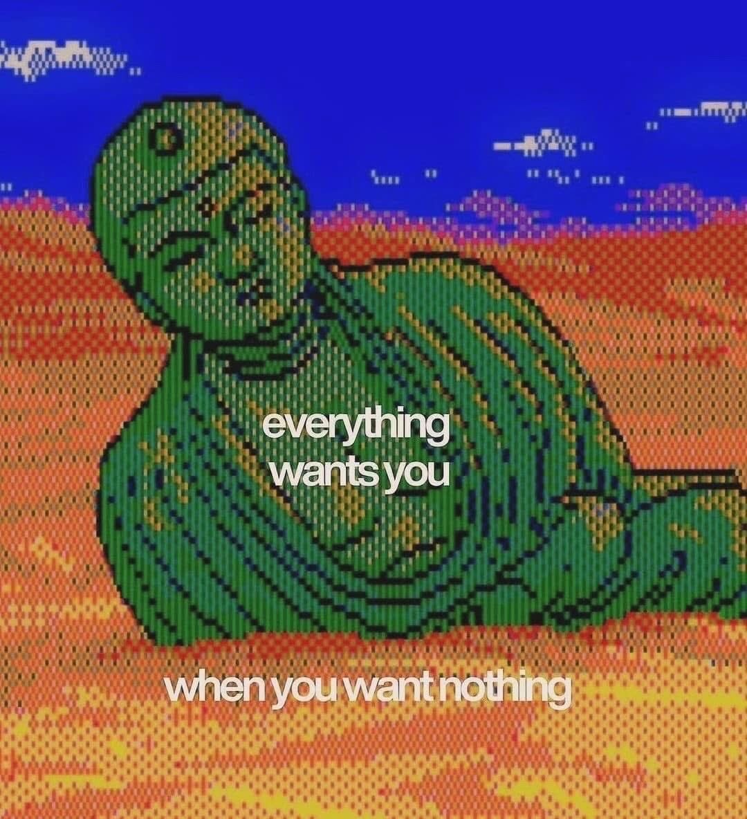 A pixel-art style image featuring a green statue of a reclining Buddha figure set against a landscape of orange and red hills under a blue sky with white clouds. The image has a retro, lo-fi aesthetic. Centered over the Buddha is text that reads 'everything wants you' and at the bottom is the text 'when you want nothing'.