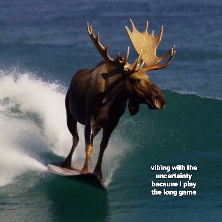 A surreal and humorous image featuring a large moose surfing on a surfboard atop a breaking ocean wave. The moose is positioned centrally, appearing to balance skillfully on the board as white sea spray kicks up behind it. In the bottom right corner, there is white text overlaid on the water.
