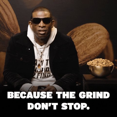A man wearing sunglasses, a white hoodie, a dark jacket, and a necklace is sitting down. He has a serious expression. The background is dark and features large, blurred shapes that resemble coffee beans. At the bottom of the image, there is white text in a bold, sans-serif font.
